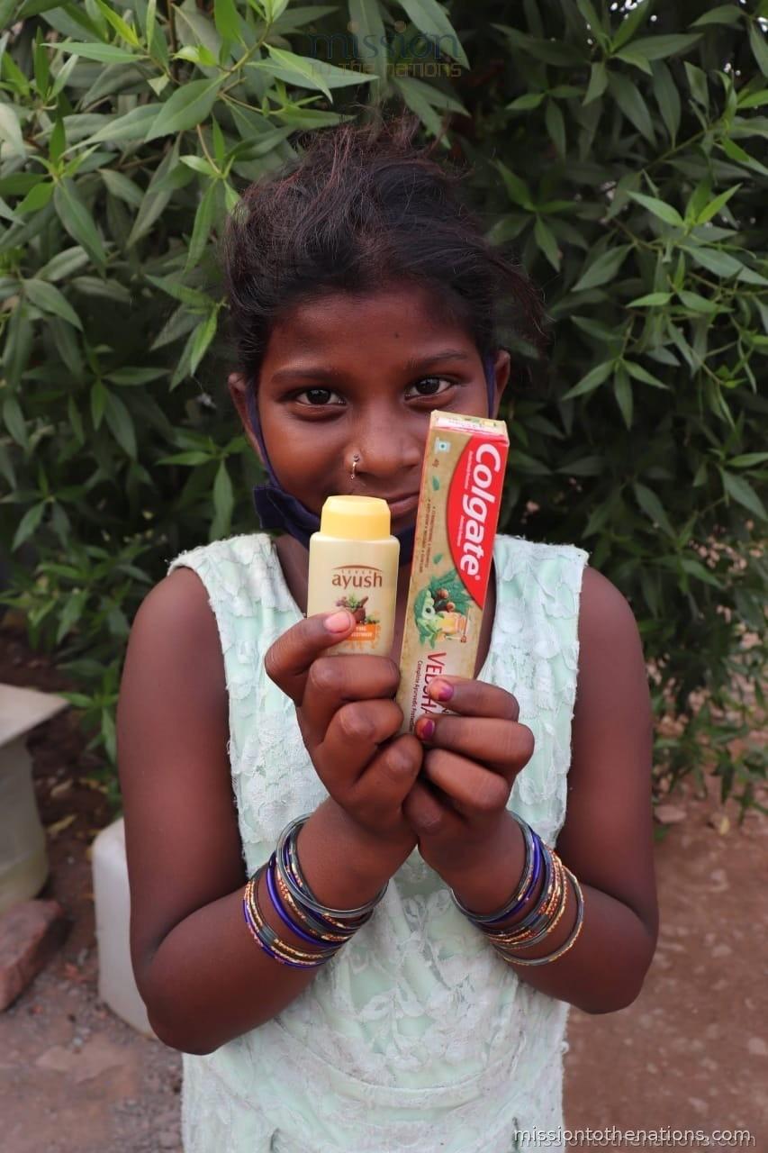 Girl with her hygiene kit — toothpaste and shampoo