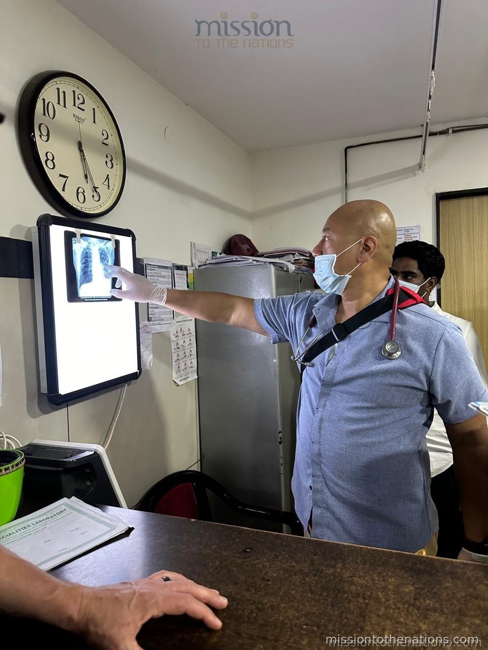 Doctor reviewing X-ray with clinical team