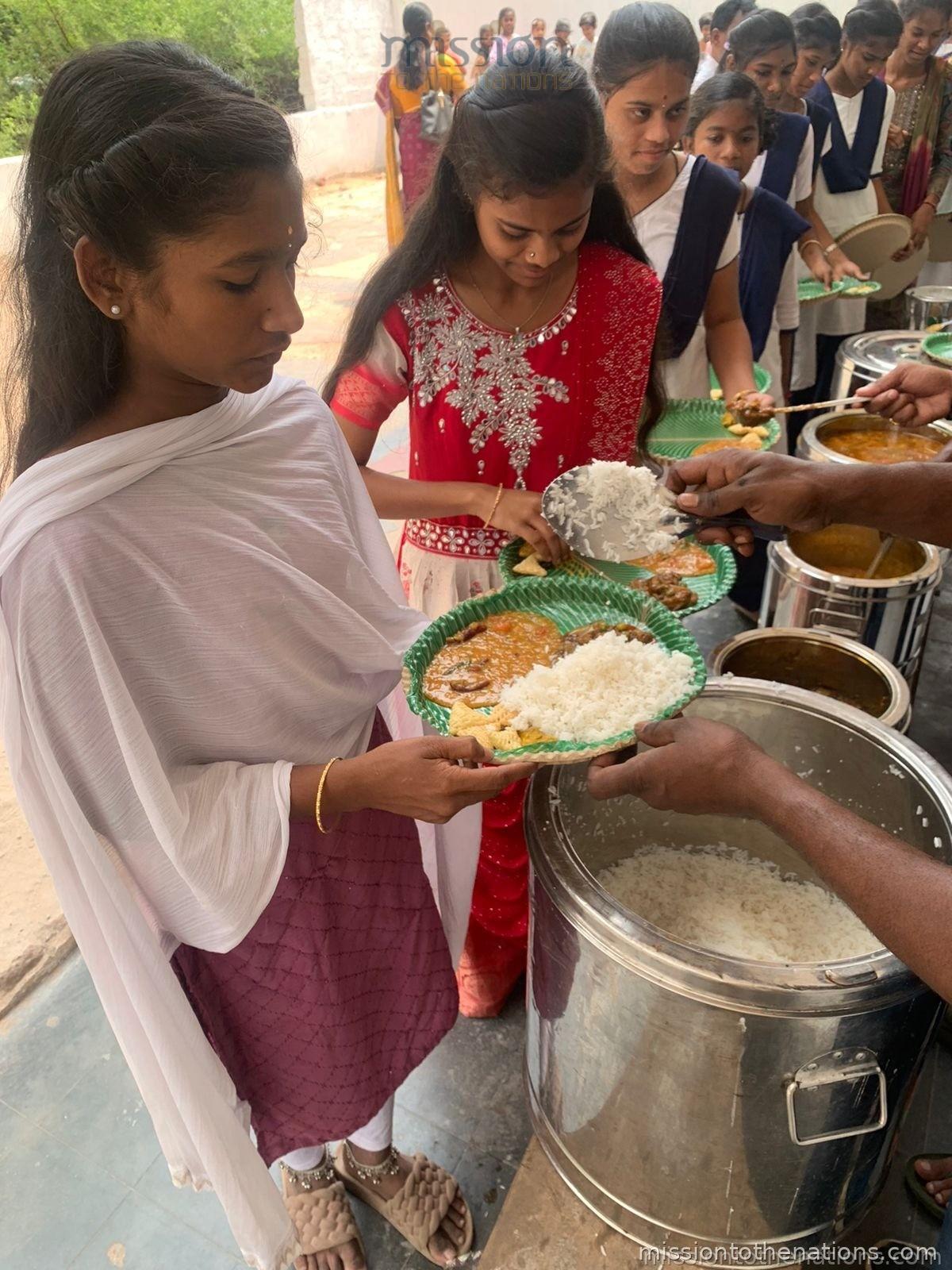 Girls at the meal serving station