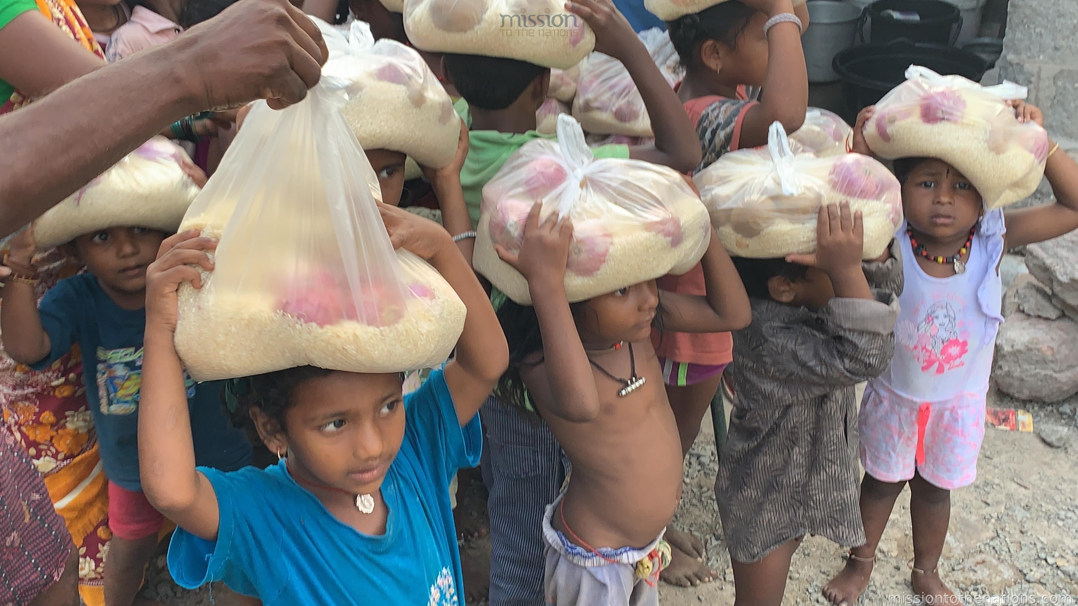 Children carrying rice home after distribution