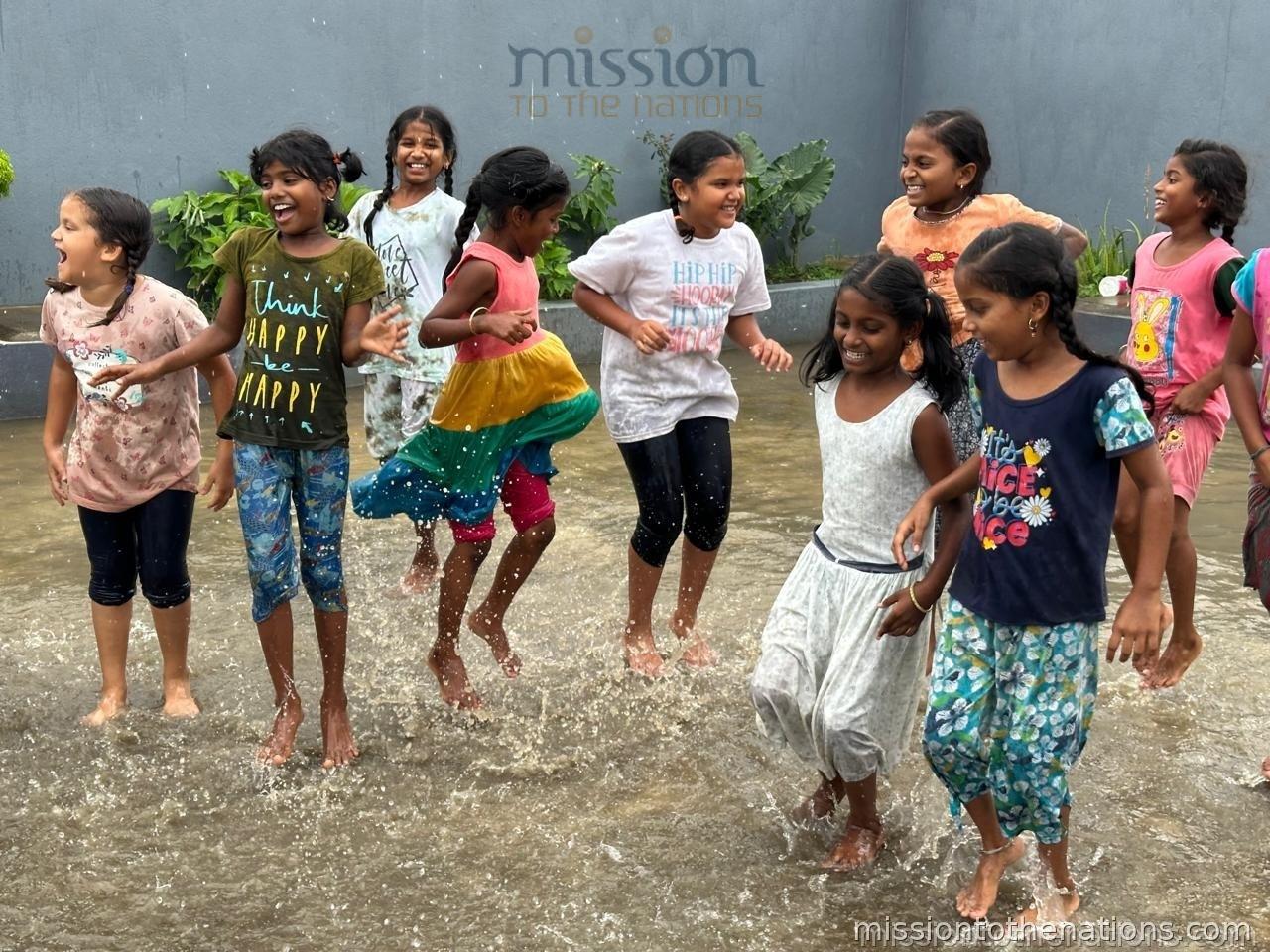Girls playing in the rain