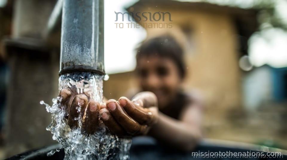 A child drinking clean water from an MTN-installed borewell tap