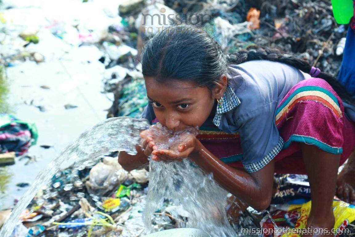 Girl drinking from contaminated drain water