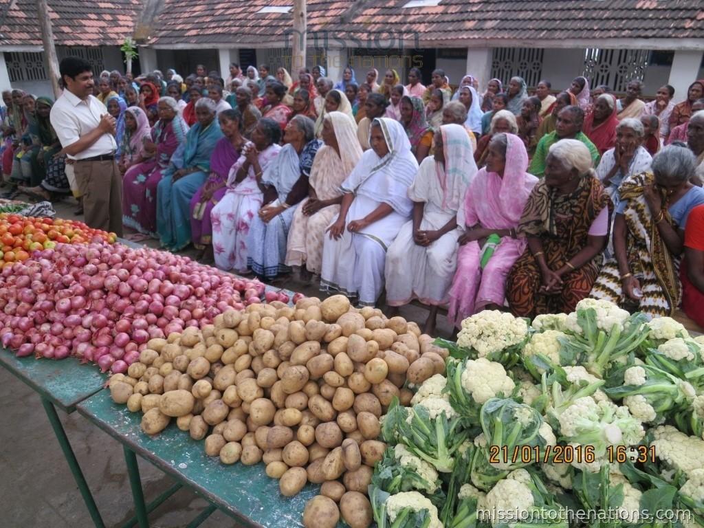 Elderly woman receiving monthly groceries from MTN