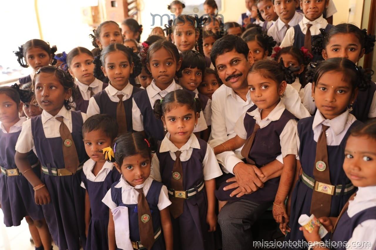 Girls in school uniforms with MTN field worker