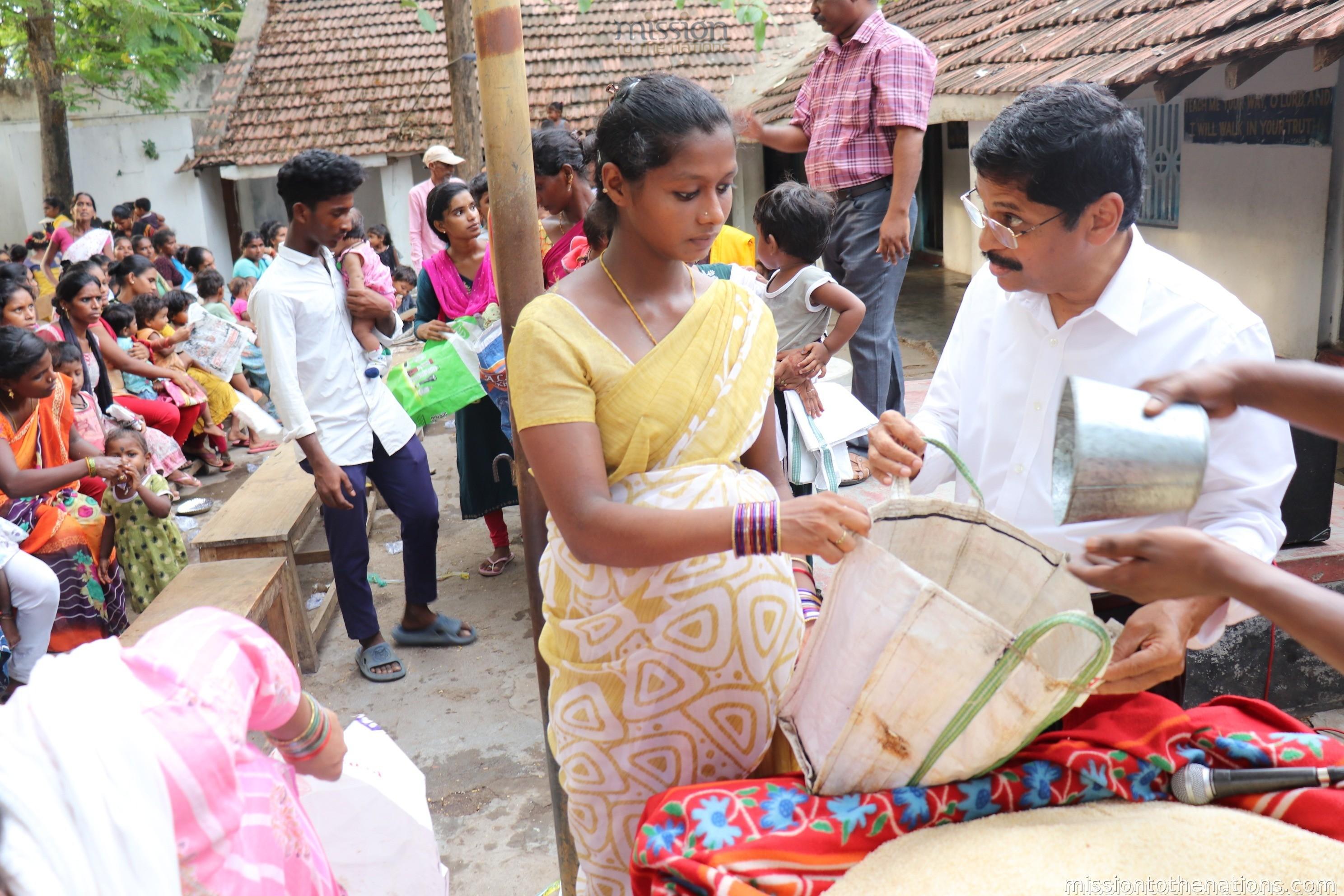 Pregnant woman receiving groceries at MTN mother and child programme