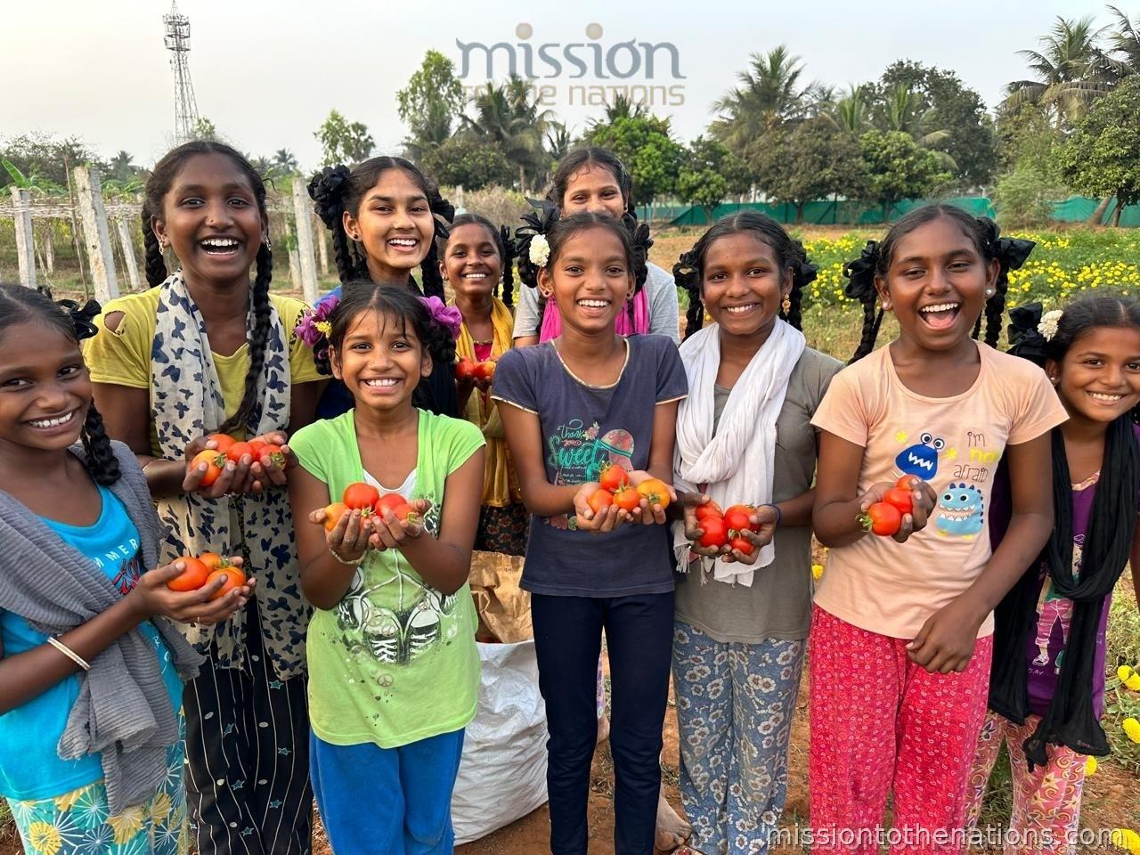 Girls with tomatoes from the school garden