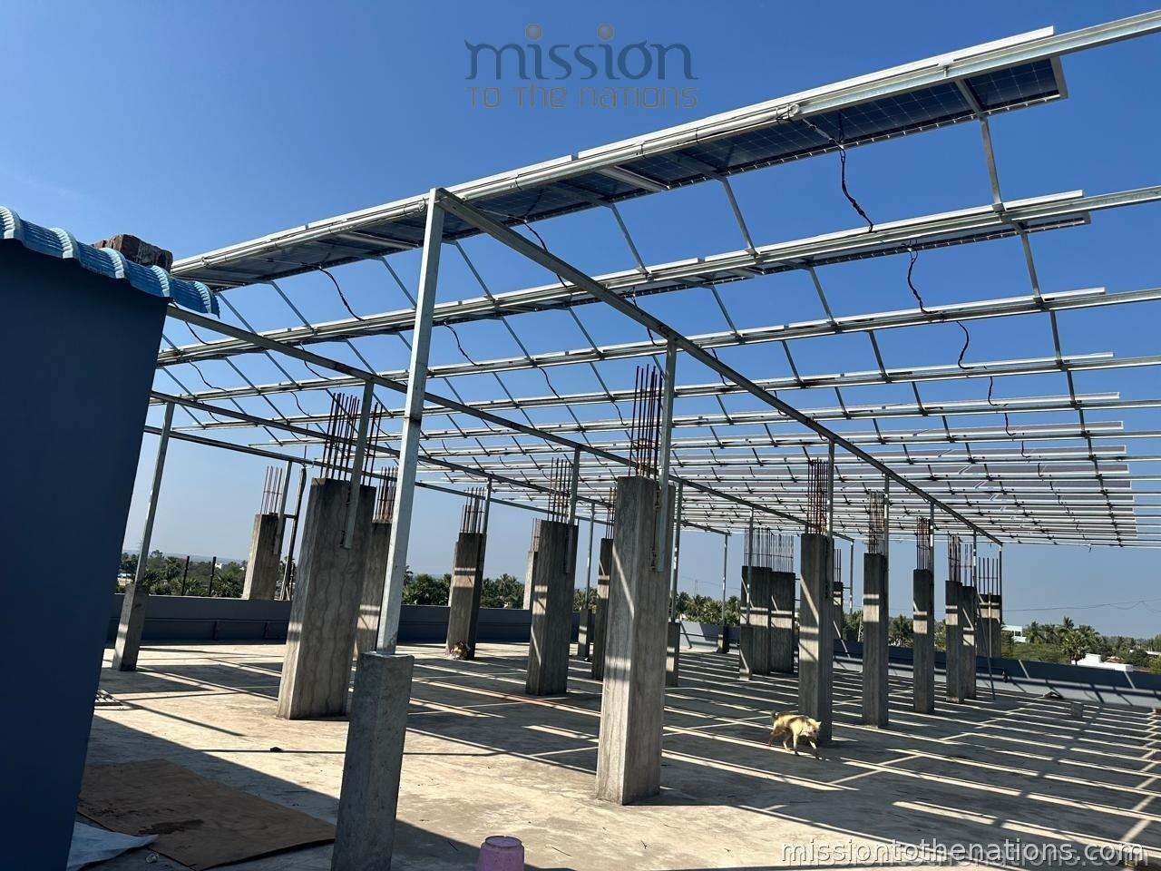 Solar panel installation under construction at a school