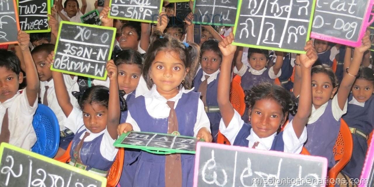 A child in an MTN school raises her slate